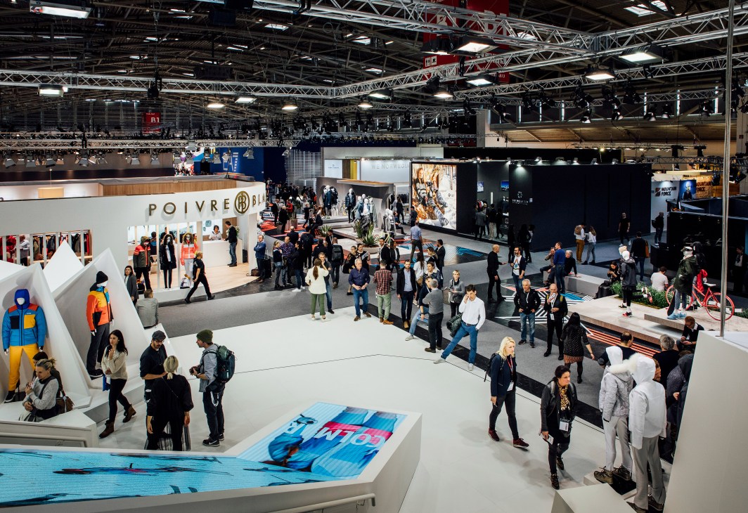 Overhead view of Ispo trade fair showing multiple exhibition stands and attendees walking through halls.