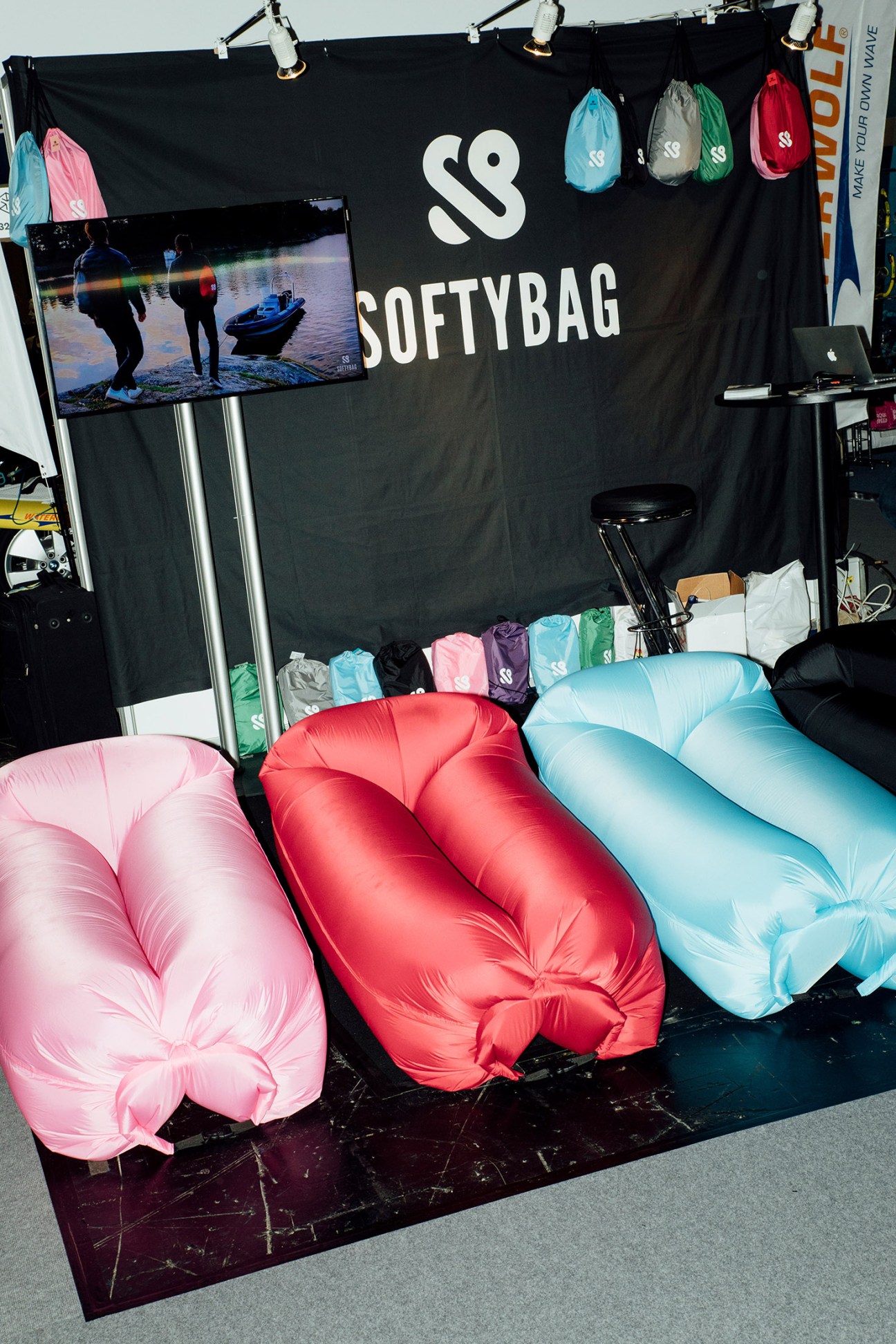 Colorful inflatable loungers displayed at Softybag stand at Ispo sportswear fair