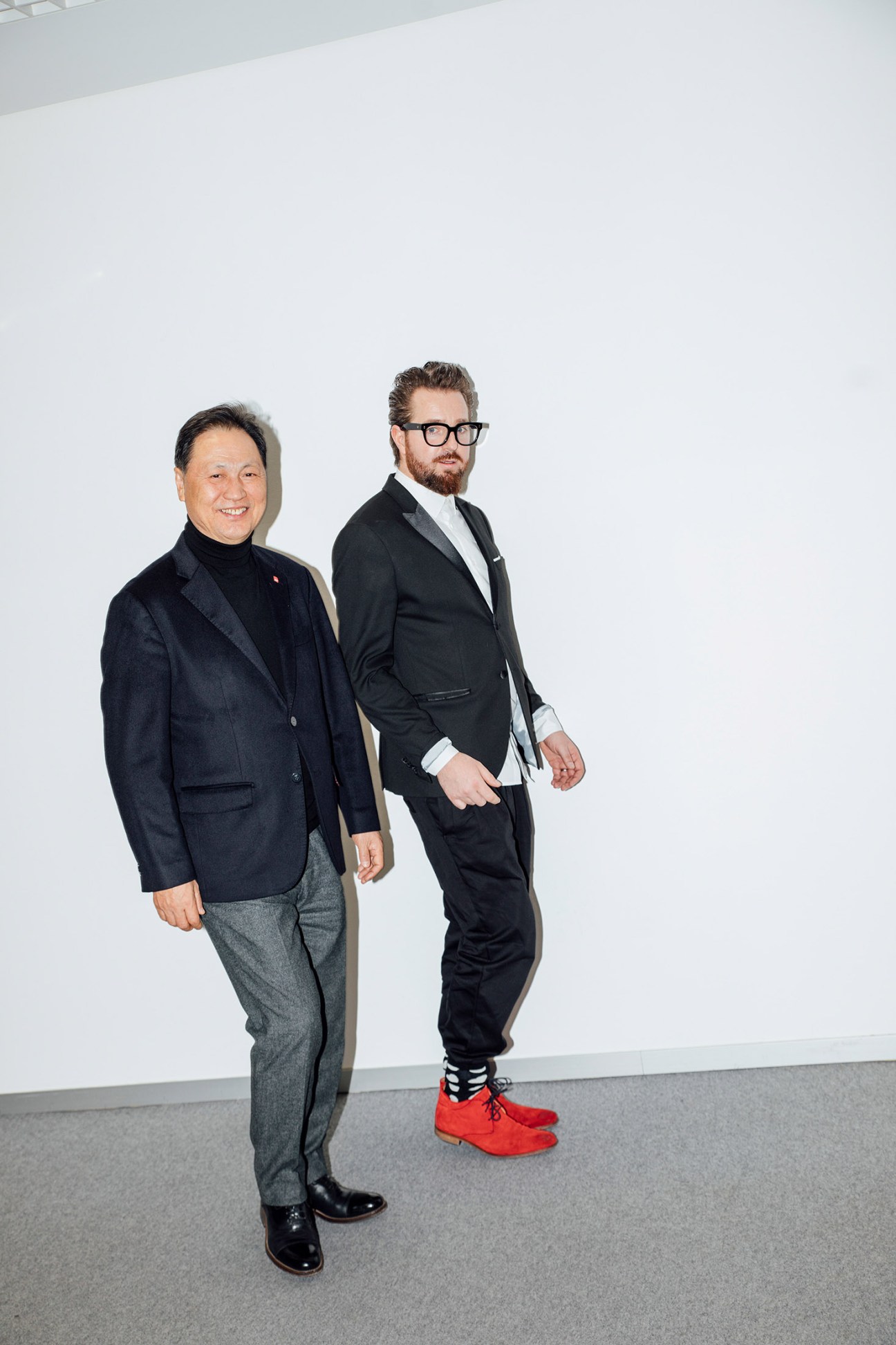 Black Yak's Tae-sun Kang and Maximilian Nortz standing against a white wall at Ispo.
