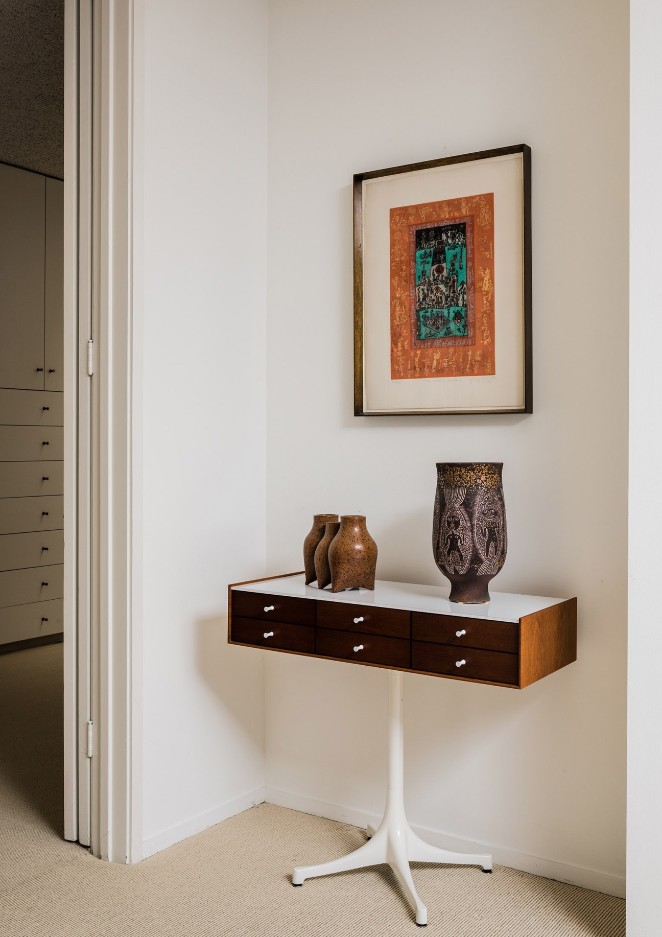 Mid-century modern wall display with George Nelson furniture and framed Ynez Johnston artwork in the Brady House.