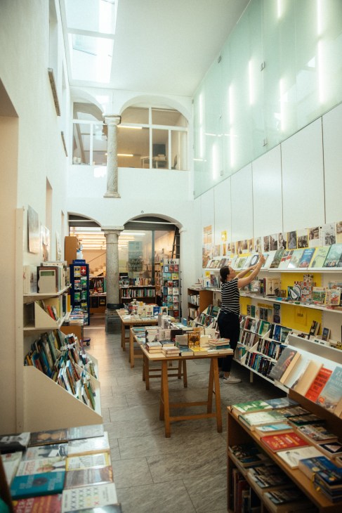 Interior of Libreria Locarnese bookshop with shelves and display tables of books