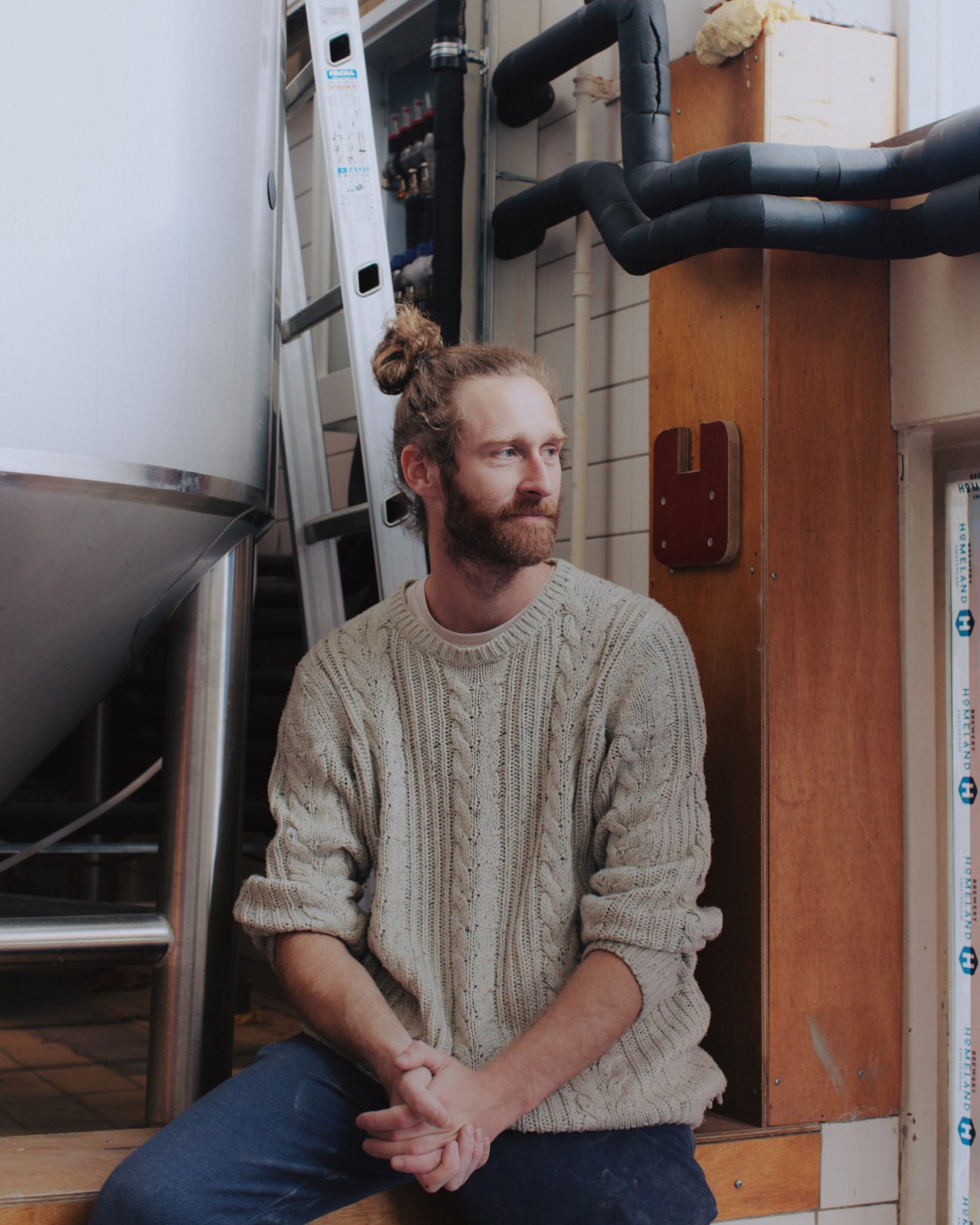 Brew master Erik Spratte sits in an industrial space at Homeland Brewery.
