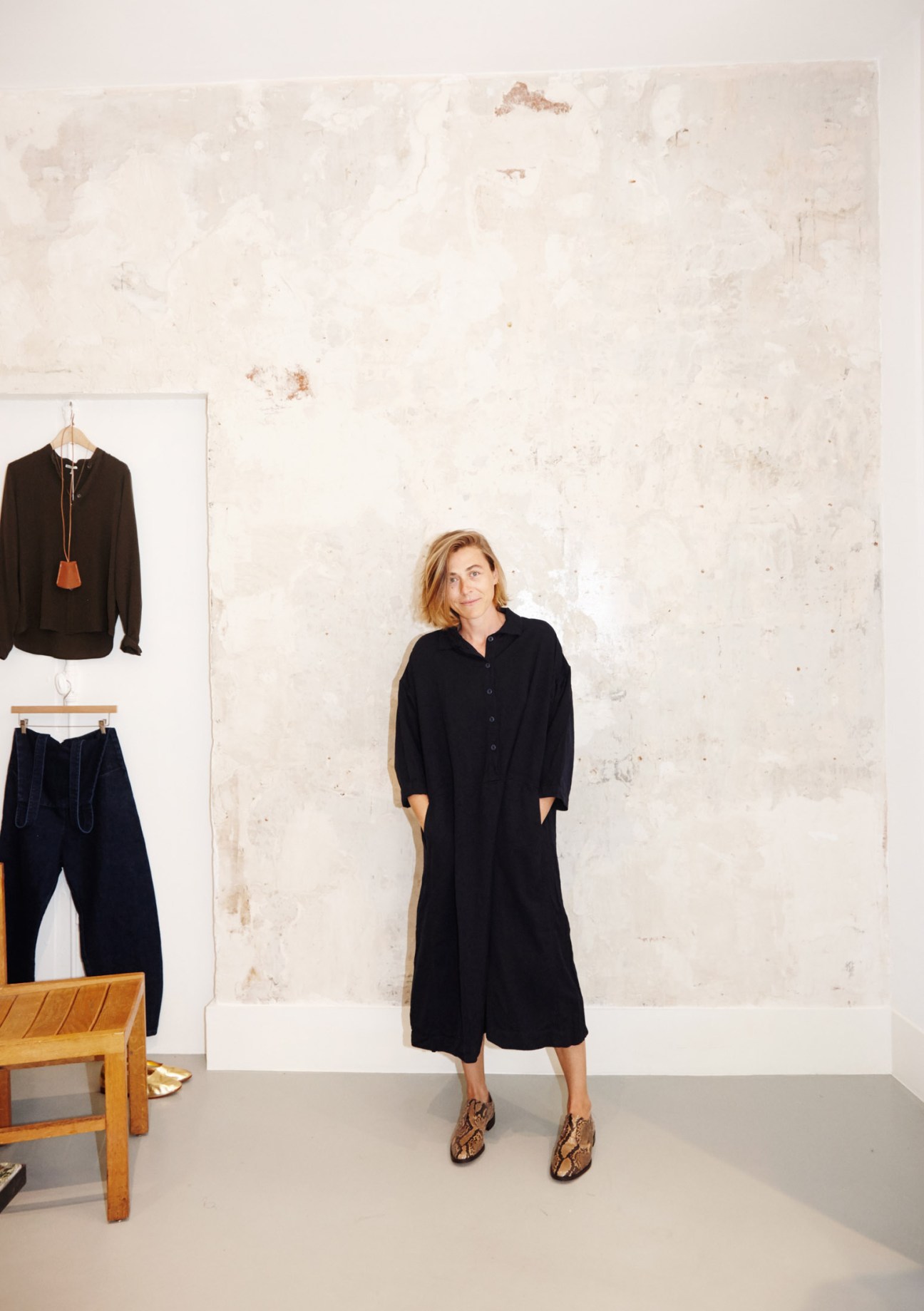 Regular client Delphine wearing a black shirt dress and patterned shoes in the Rendez-vous womenswear shop.
