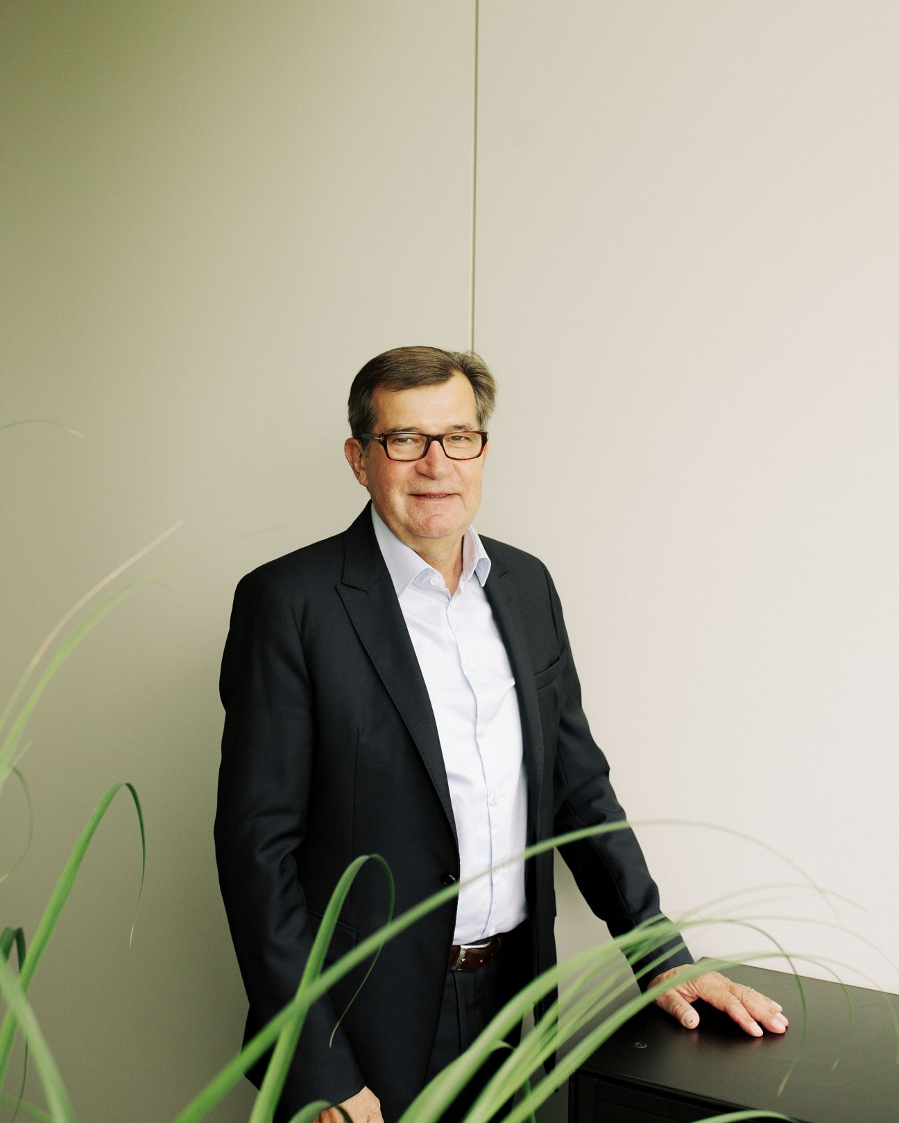 Gottfried Wanzl, chairman of the board, wearing glasses and a dark blazer with white shirt.