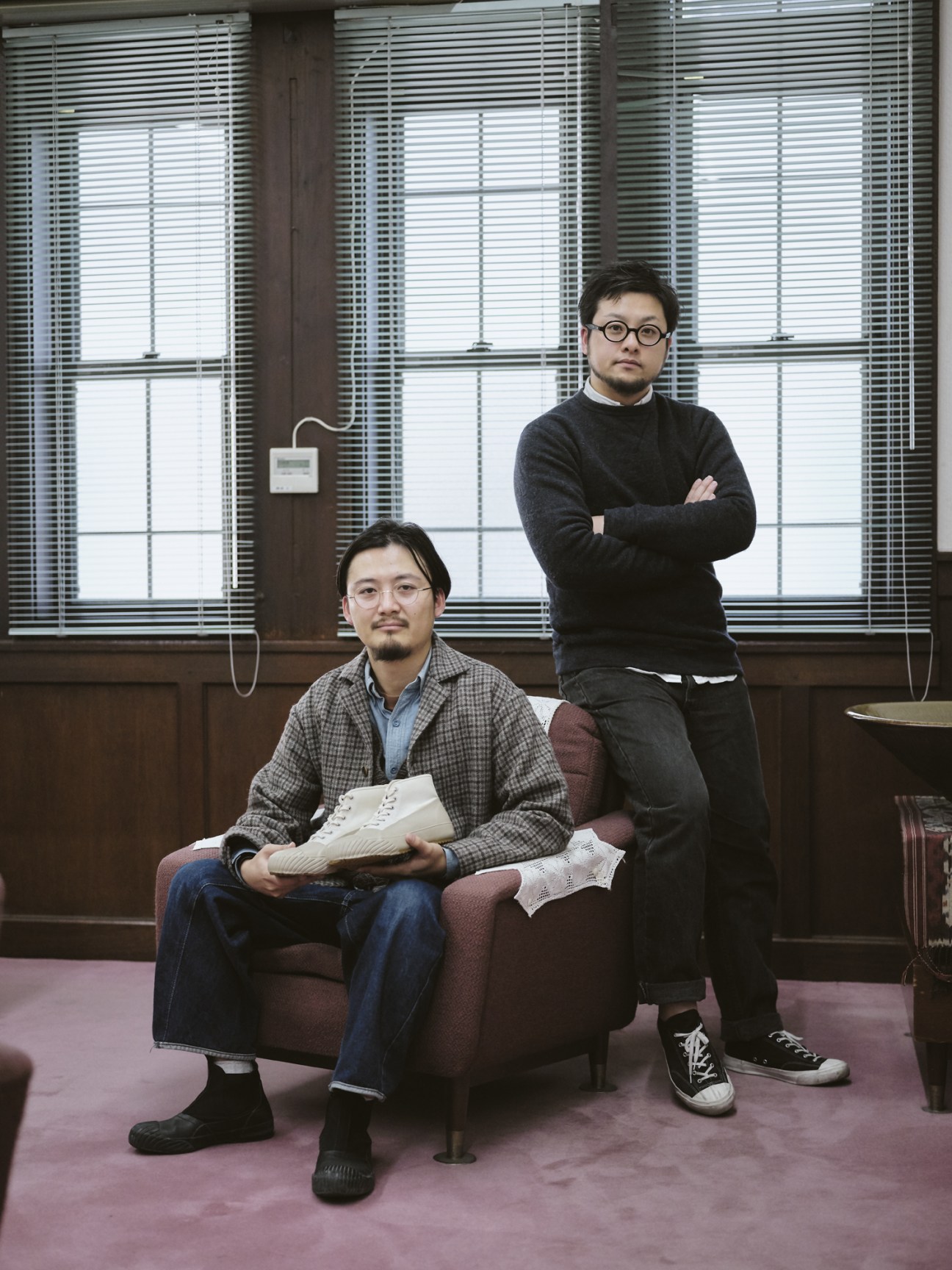 Kenta Matsunaga and Sotaro Yamada from Moonstar pose together in a sunlit office with venetian blinds behind them.