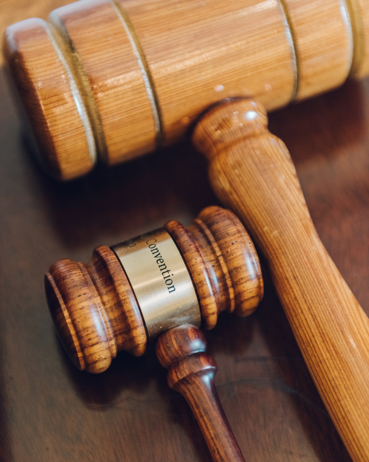 Wooden gavel with metal nameplate reading 'prevention' on wooden surface