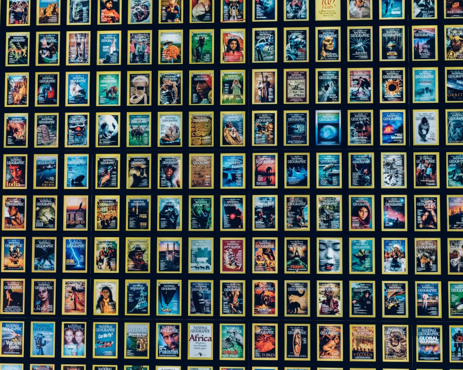 Wall display of National Geographic magazine covers arranged in rows from 1888 to present day