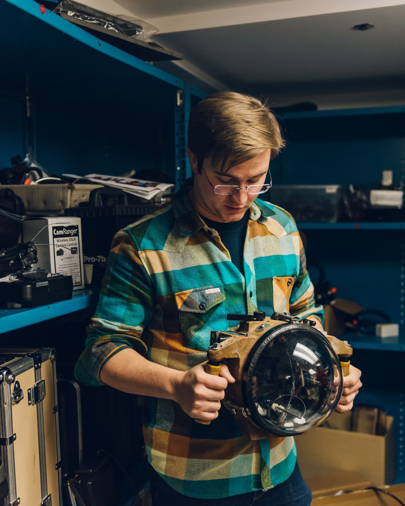 Engineer Tom O'Brien holds an underwater camera in National Geographic's studio.