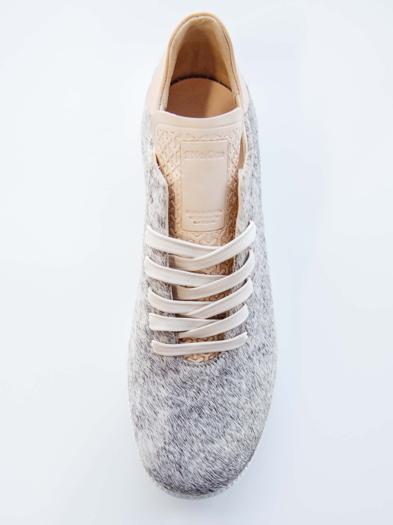Close-up of white NoOne trainers showing premium craftsmanship and materials