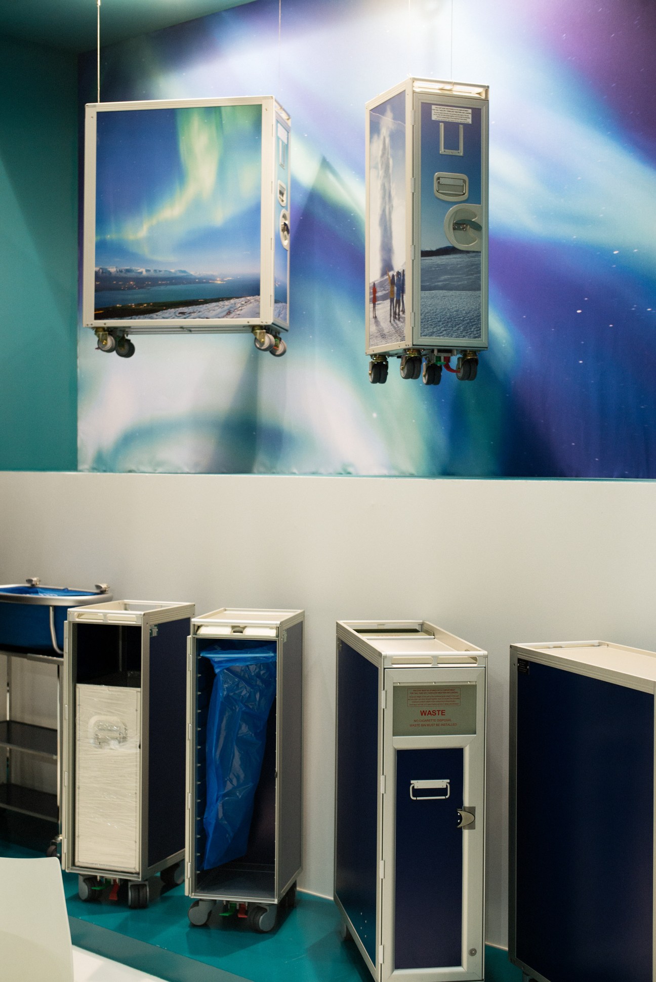 Aurora-decorated galley carts with wheels displayed at Aircraft Interiors Expo.