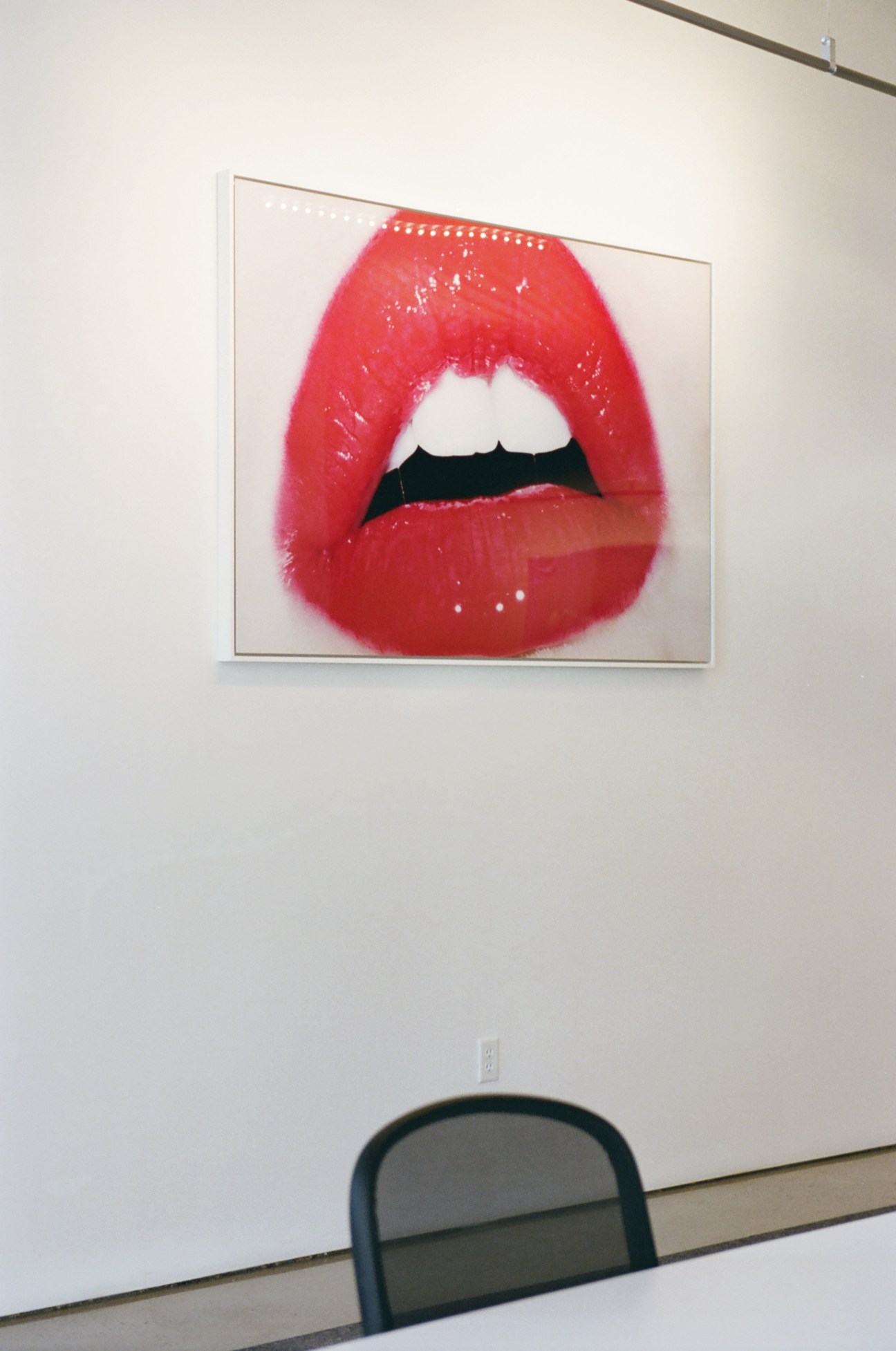 Framed photograph of bright red lips against white background by photographer Terry Richardson