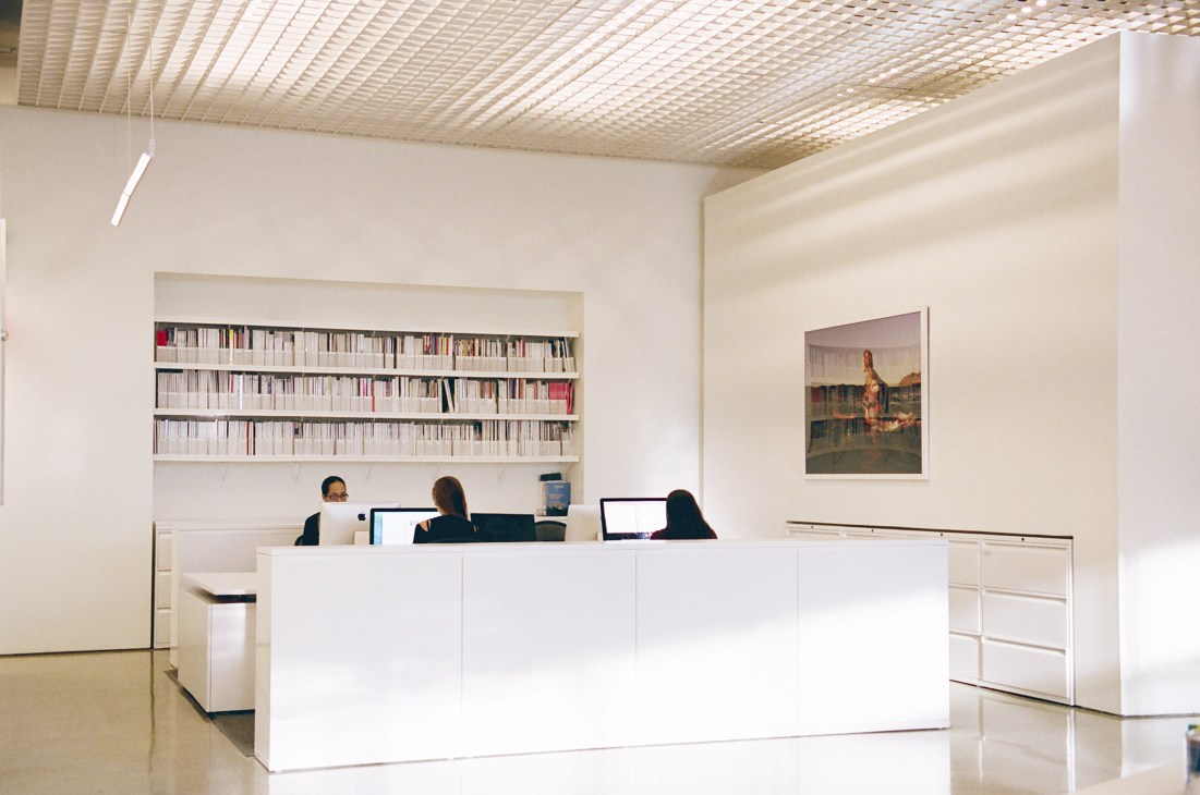 Open office space with desk workers and computers showing busy work environment during extended hours.