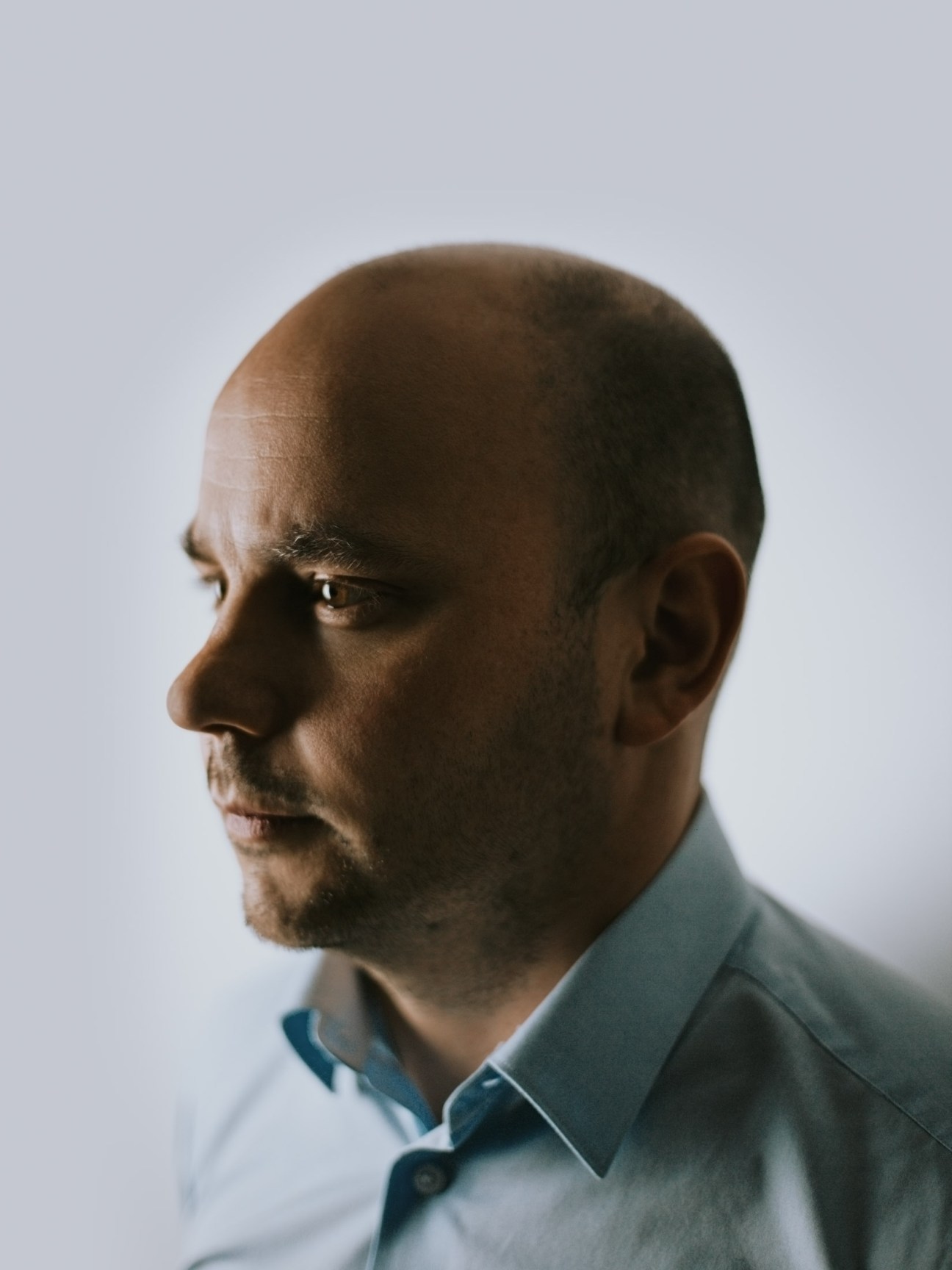 Profile portrait of Andrei Pivovarov, Open Russia chairman, against a light background.