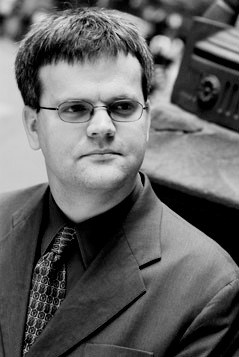 Malcolm Cook, programme director for the Asia Pacific region at the Lowy Institute, in a black and white portrait photograph.