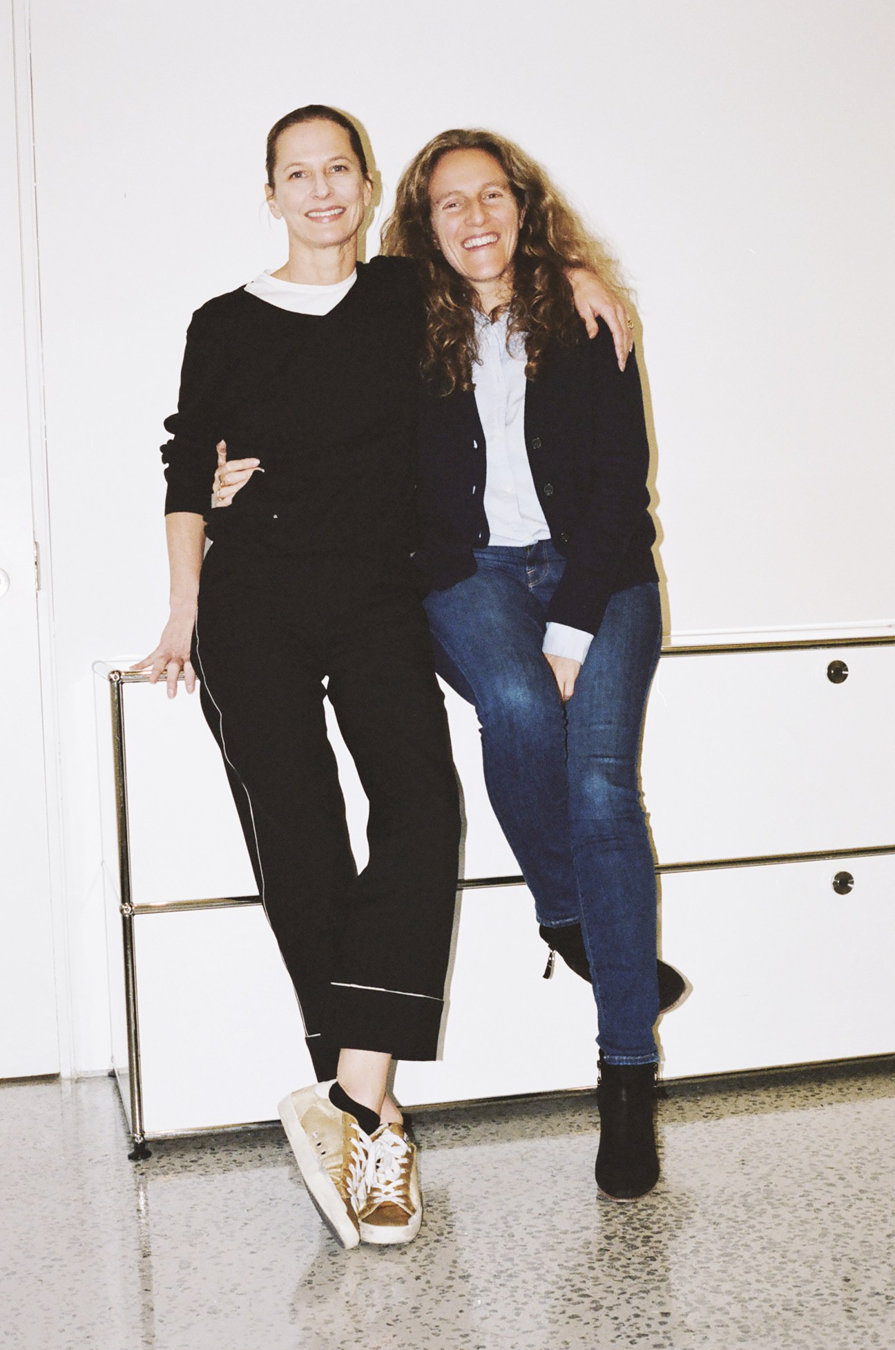 Amber Olson and Candice Marks pose together smiling in an office setting