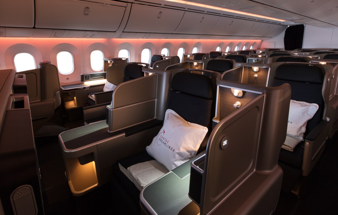 Qantas Boeing 787 Dreamliner cabin interior with business class seats and adjustable lighting.