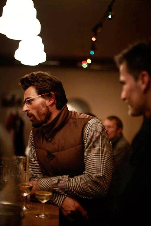 Man wearing Valstar vest and Visvim shirt at a Berlin bar with drinks