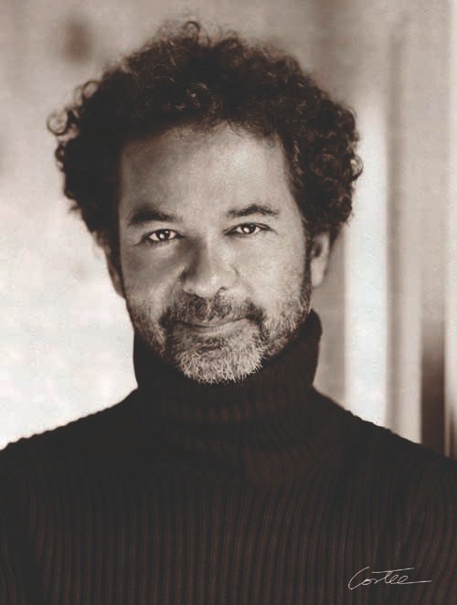 Portrait of Remo Ruffini, president of Moncler, wearing a black turtleneck.