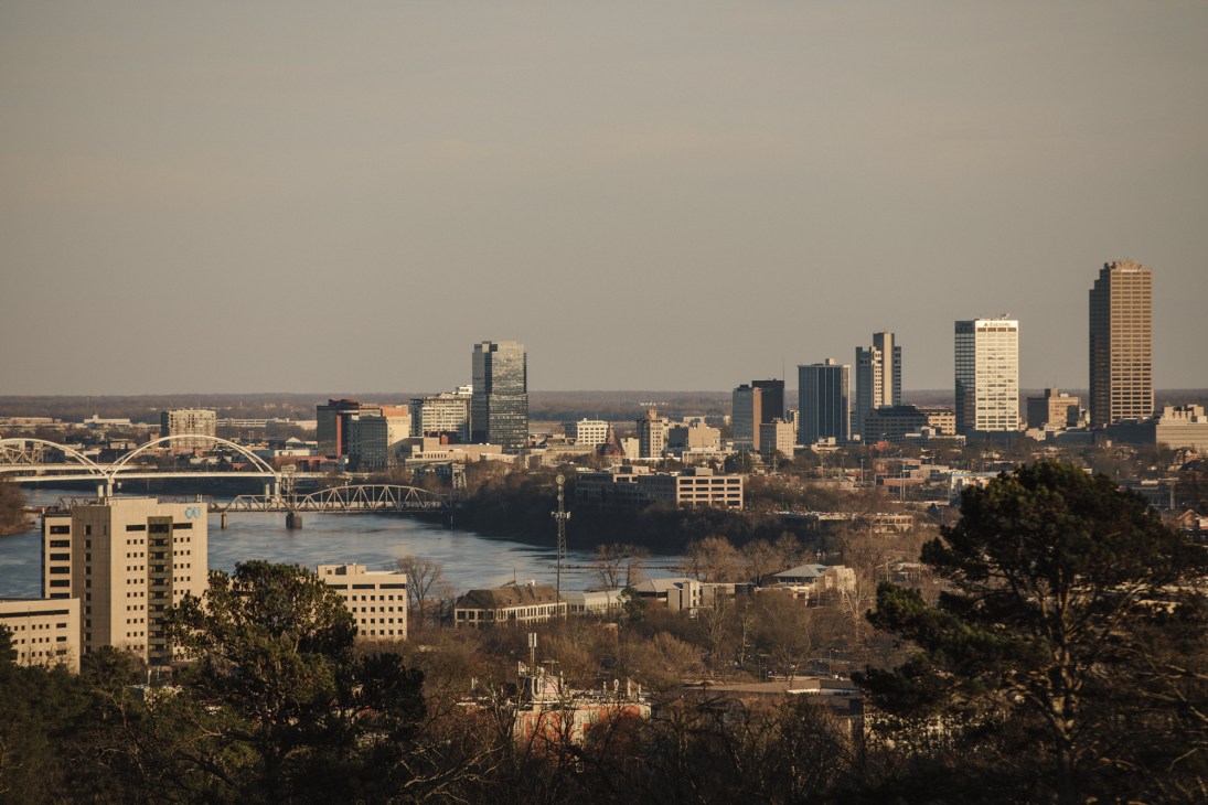 Panoramic view of Little Rock's downtown skyline with bridges spanning the Arkansas River