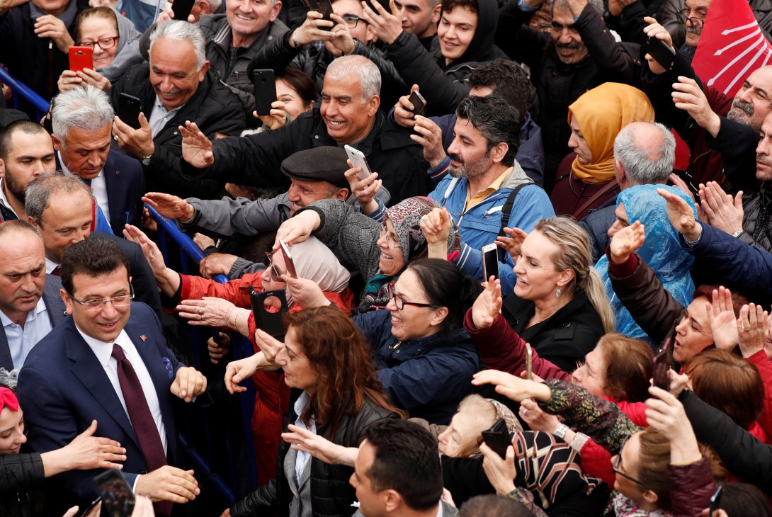 Mayor Ekrem Imamoglu greeting enthusiastic crowd of supporters reaching out to shake hands and take photos