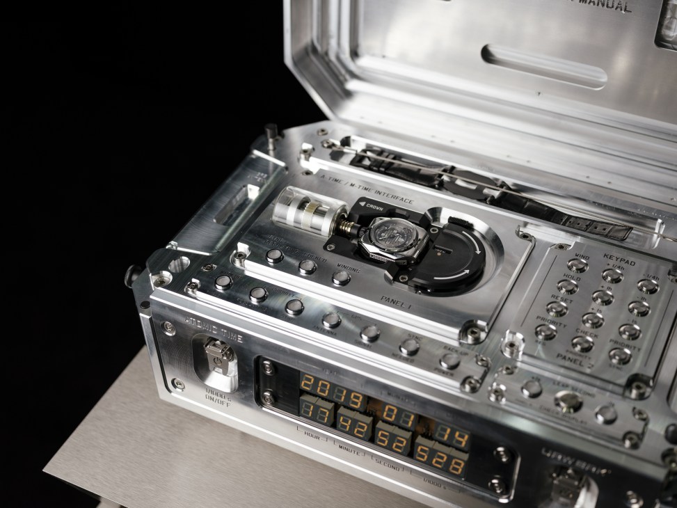 The AMC atomic-clock hybrid by Urwerk with exposed mechanisms and digital display in an open case