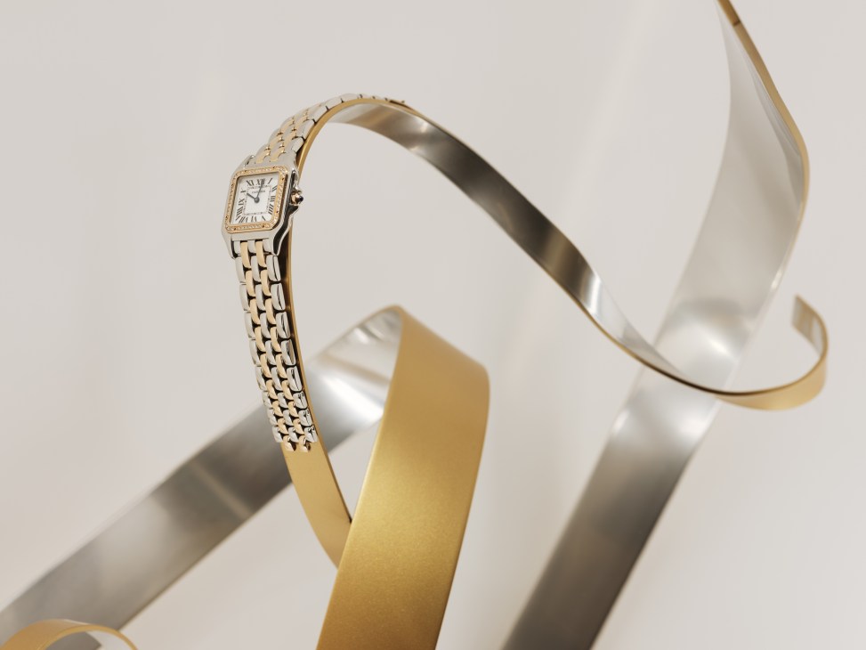 Cartier luxury watch with rectangular face and metal bracelet displayed on white ribbon.