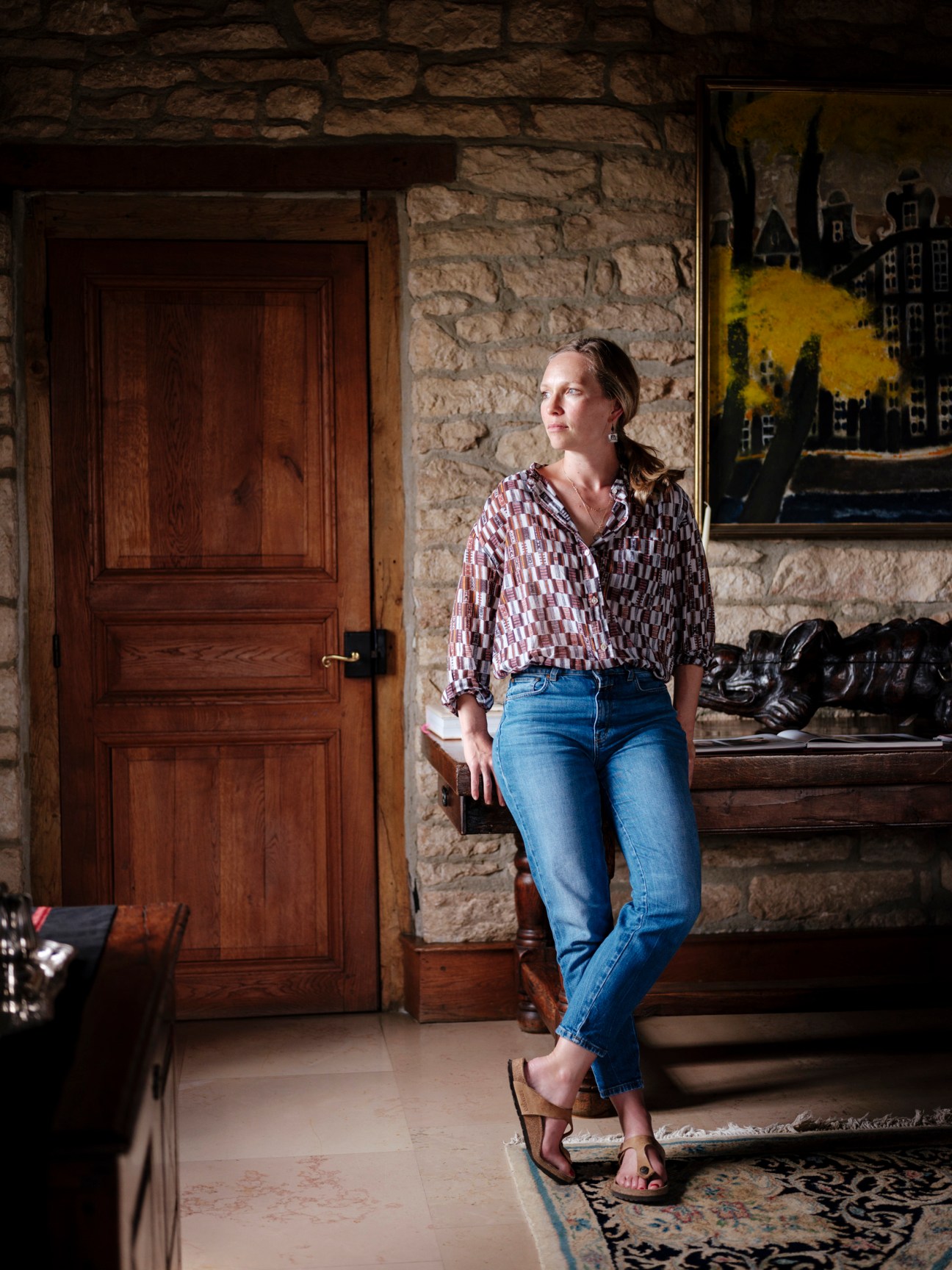 Diana Seysses standing in a stone-walled room at the Dujac family home in Burgundy.