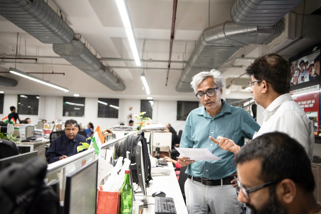Senior editor Shankar Raghuraman discusses story ideas with colleagues in Times of India newsroom.