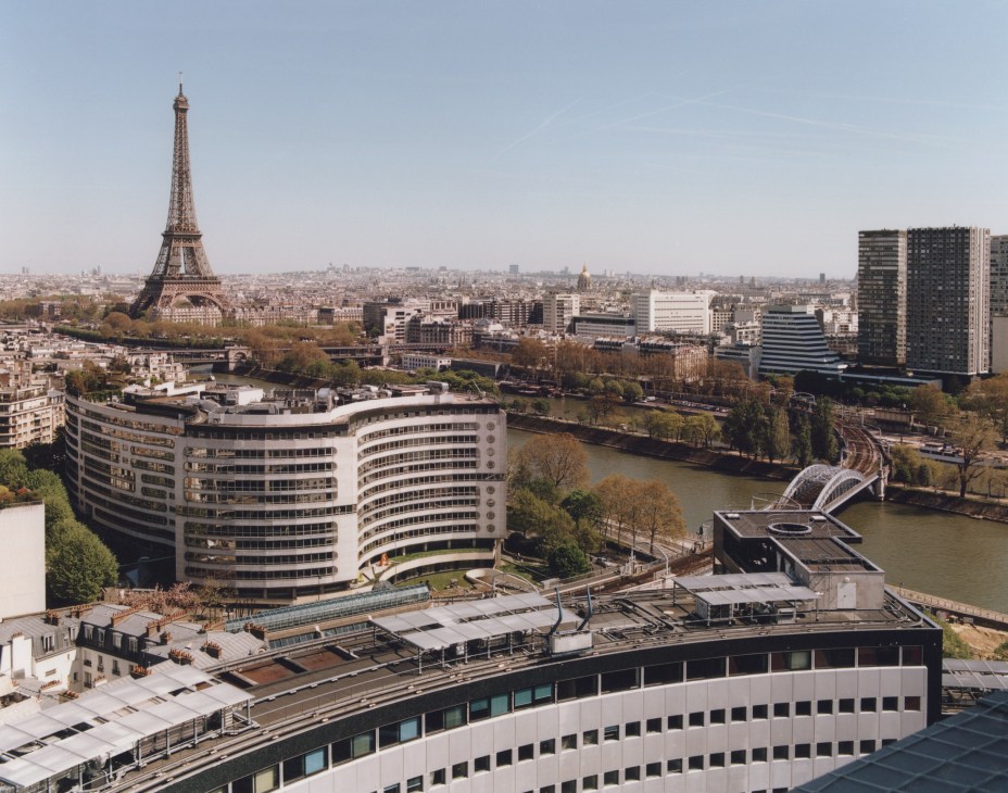 Paris skyline view from Maison de la radio showing the Eiffel Tower, Seine river, and surrounding cityscape.