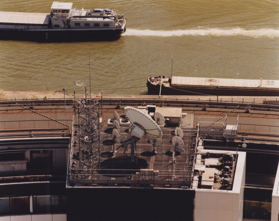 Aerial view of radio transmitters and satellite dishes on the rooftop of Maison de la radio overlooking the Seine River.