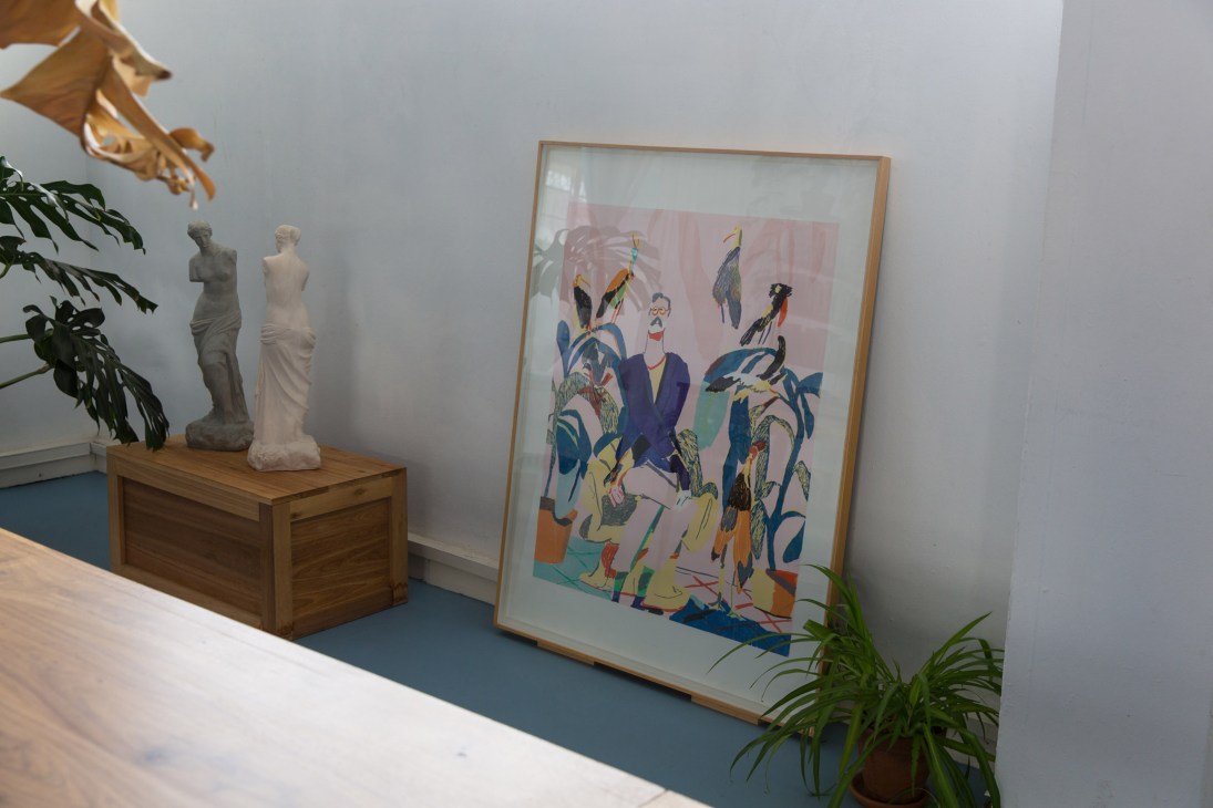 Interior of Morné Visagie's studio with white sculptures, framed colorful artwork, and potted plants.