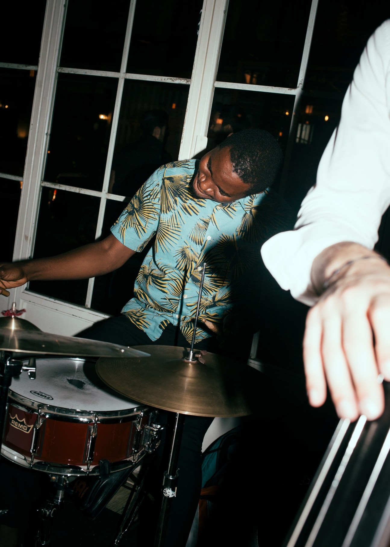 Drummer in turquoise patterned shirt performing at Aaliya's Books bar in Beirut.