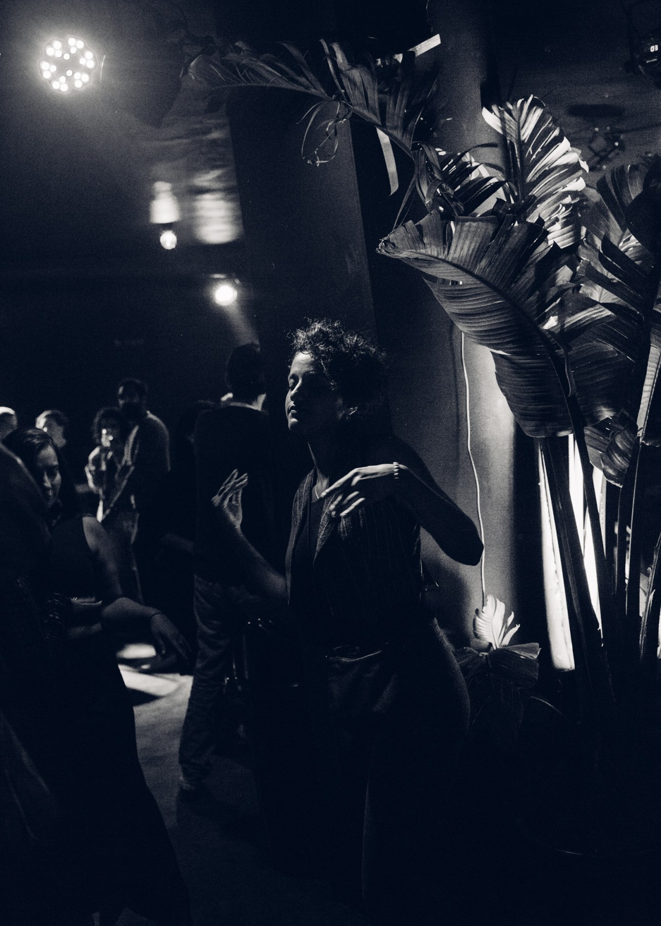 Revellers dancing at KED nightclub with banana plants and disco ball lighting in Beirut.