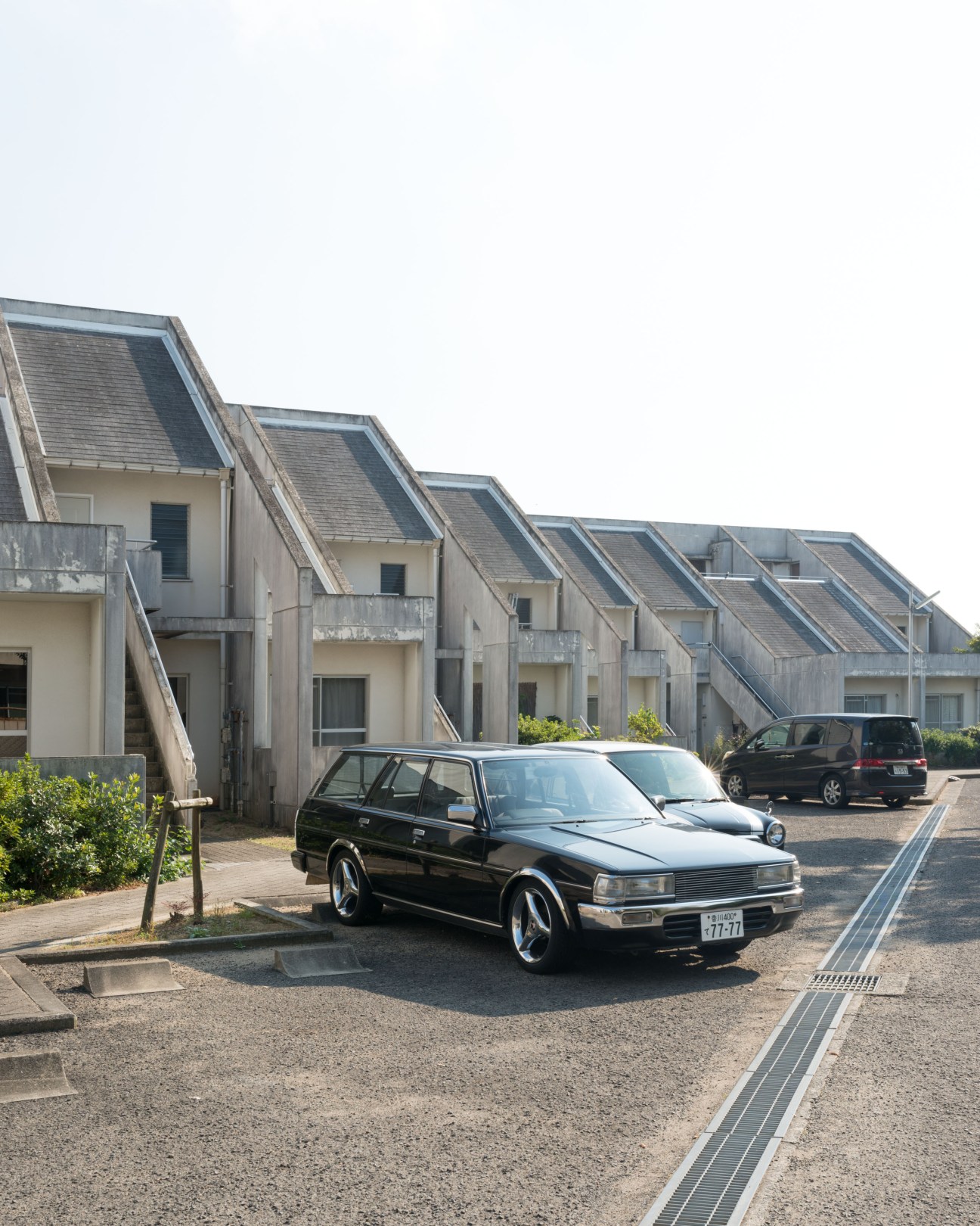 Kenzo Tange's Ichinomiya Danchi housing complex with angled roofs and concrete construction.