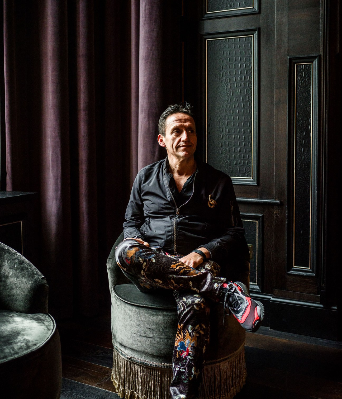 Restaurant consultant Robbie Bargh sitting in an upholstered chair in The Principal hotel's lobby.
