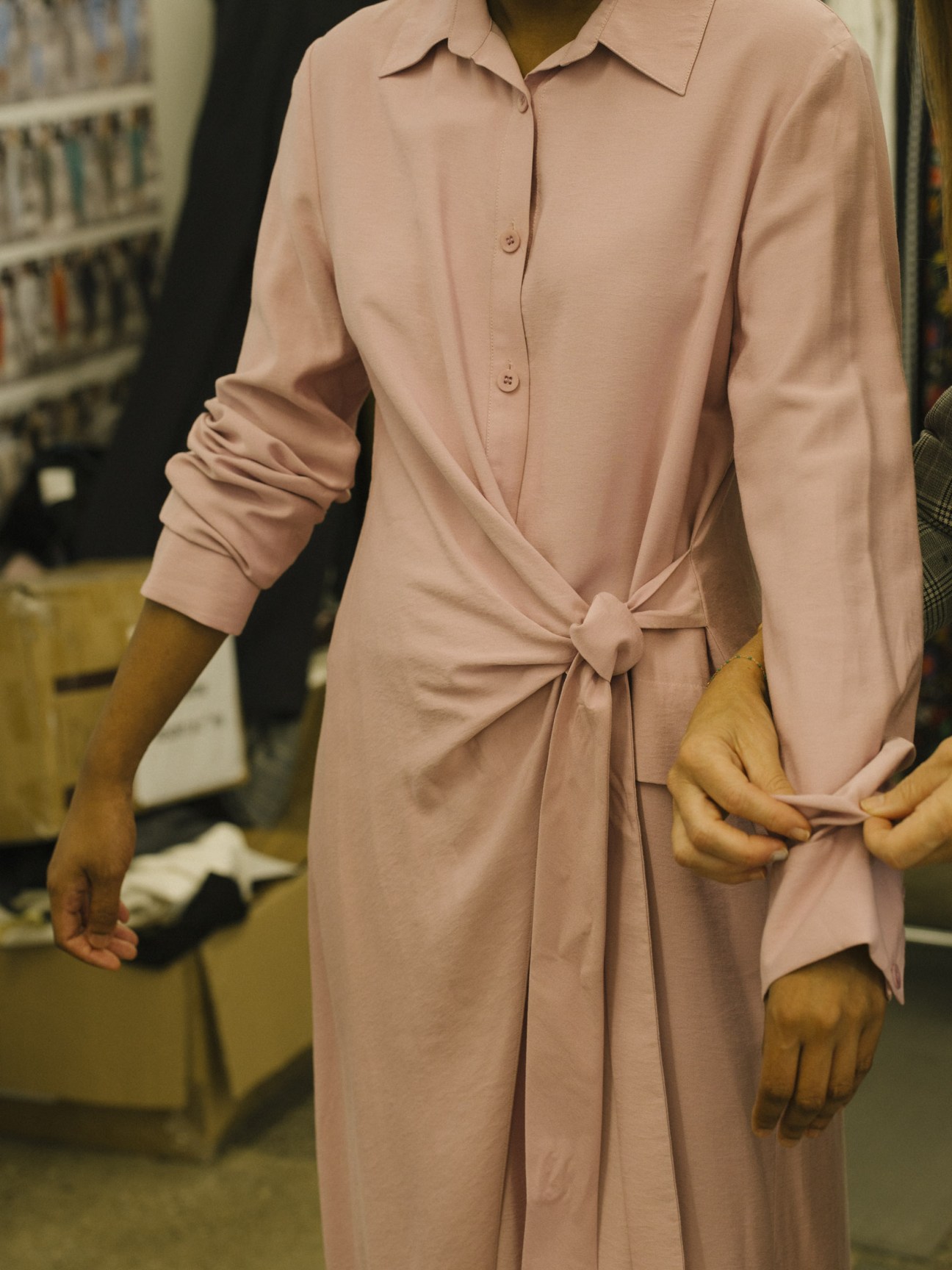 Amy Smilovic fits a tie-detailed shirt dress from fall 2019 to a fit model