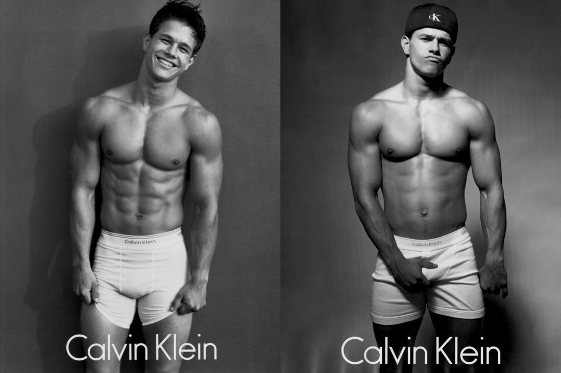 Black and white Calvin Klein underwear campaign featuring two shirtless men in white briefs against plain background.