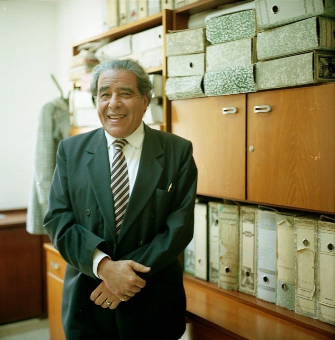Mohamed Qraiem, spokesman for Tunis town hall, smiling in an office with filing cabinets.