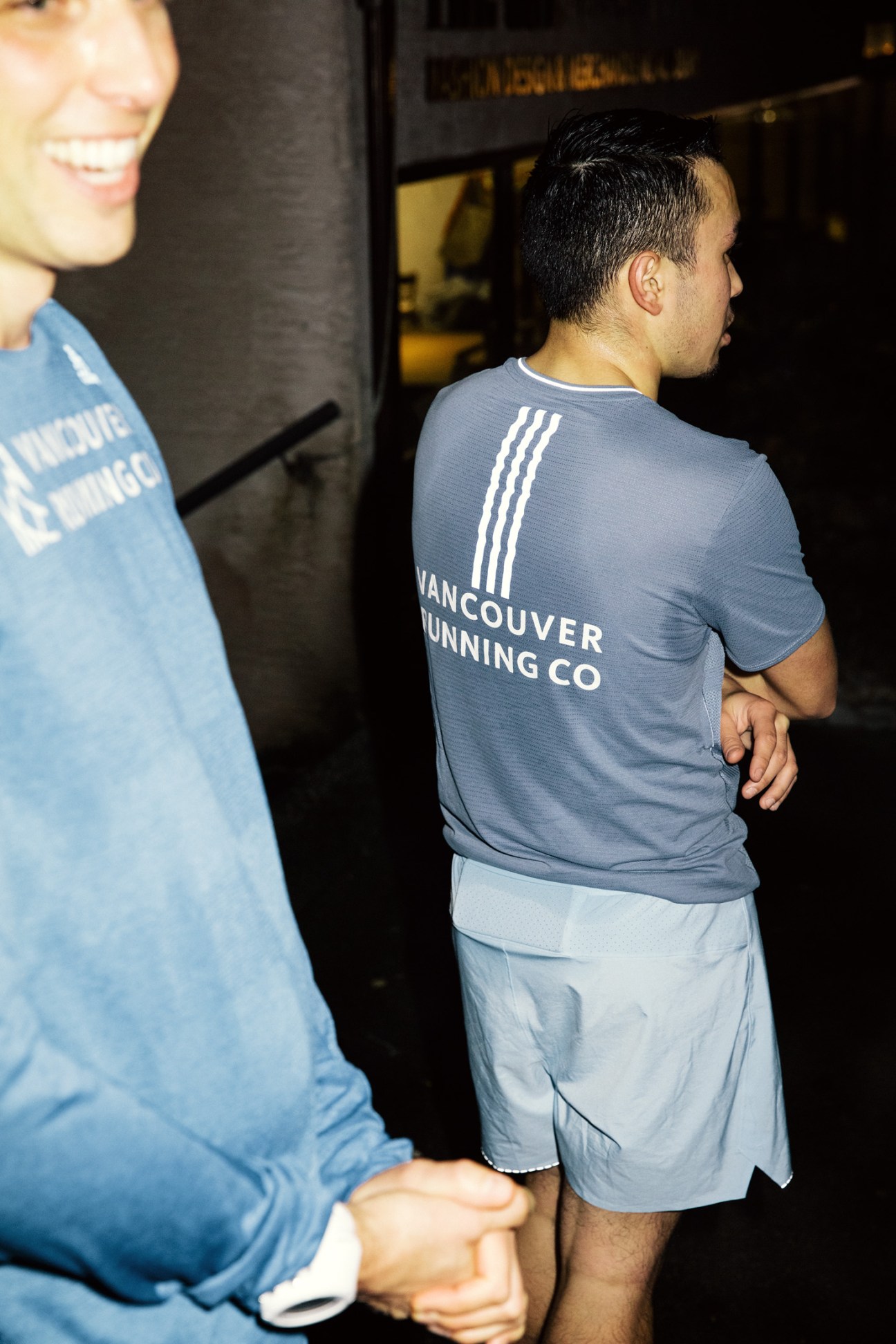 Runners wearing Vancouver Running Co branded shirts cool down after a group run.