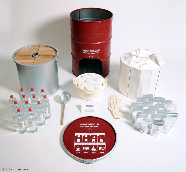 Heat Rescue disaster recovery kit with red barrel stove, water bottles, utensils, and supplies displayed on white background.