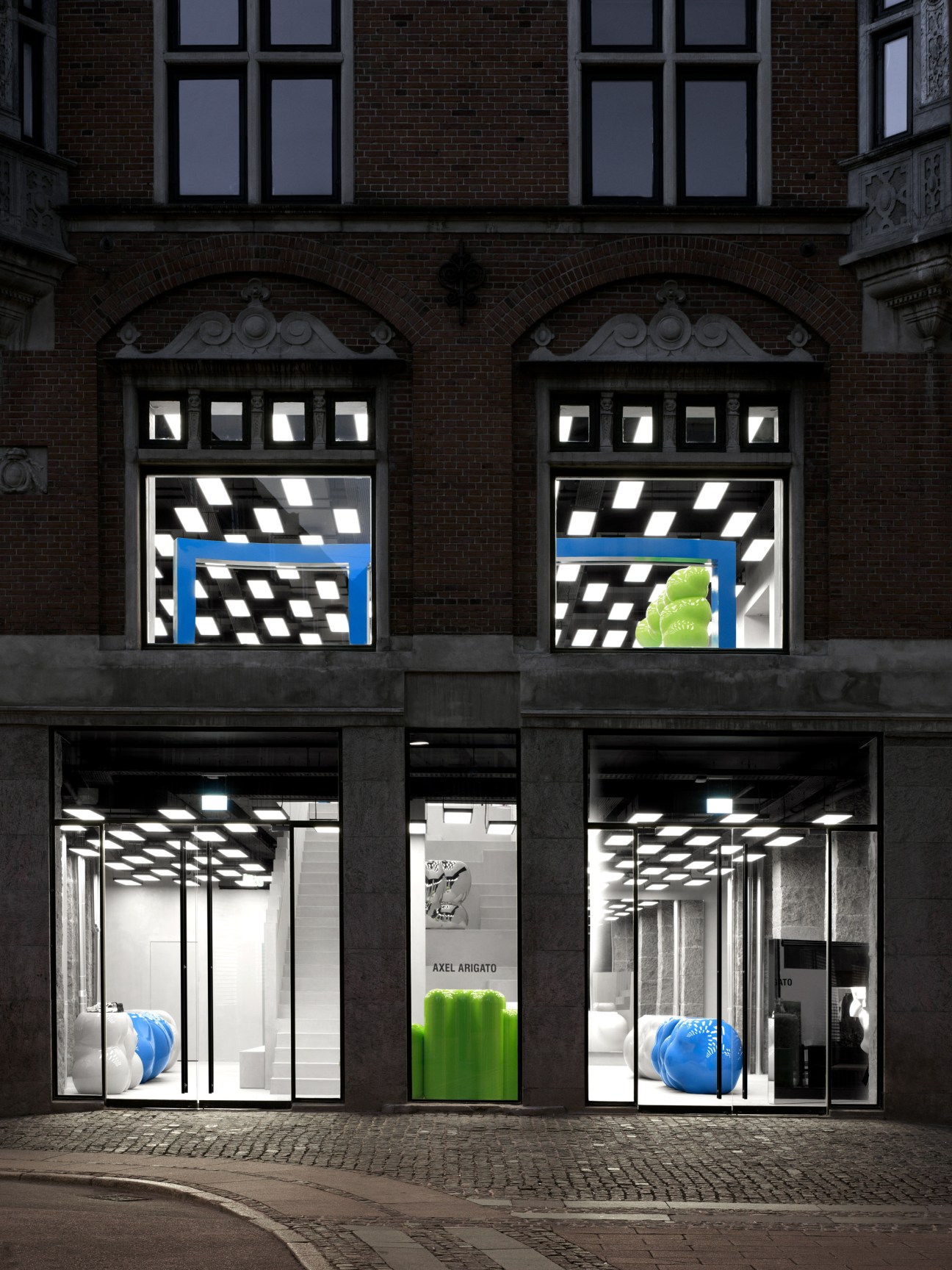 Storefront of Black Forest listening bar in Buenos Aires with large windows displaying interior and signage.